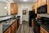 Black Kitchen Appliances and Maple Cabinetry at Abberly Woods Apartments in Charlotte, NC