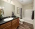 Plank Flooring and Modern Fixtures in Bathroom at Abberly Woods Apartments in Charlotte, NC