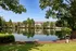 A pond with a sign in front of a building at Abberly Twin Hickory Apartments in Glen Allen, VA