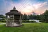 a gazebo with a sunset in the background  at Abberly Twin Hickory Apartment Homes, Glen Allen