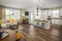 Living room with kitchen space at Abberly Market Point Apartments in Greenville, SC