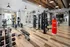 Modern fitness center equipped with cardio machines and free weights at Abberly Noda Vista Apartments in Charlotte, NC