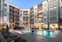 An apartment complex with buildings and a resort-style pool at dusk at Abberly Noda Vista Apartments in Charlotte, NC