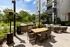 A patio with a table and chairs and a grilling area at Abberly Noda Vista Apartments in Charlotte, NC, 28206
