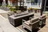 An outdoor seating area with chairs and a firepit in front of a building at Abberly Noda Vista Apartments in Charlotte, NC