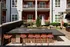 An outdoor patio with a firepit and tables and chairs in front of an apartment building at Abberly Noda Vista Apartments in Charlotte, NCa bar and stools in front of an apartment building  at Abberly Noda Vista Apartment Homes, North Carolina, 28206