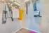 A walk-in closet with clothes hanging on the rails at Abberly Noda Vista Apartments in Charlotte, NC