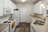Kitchen with Double Sink and White Cabinets at Abberly Green Apartments in Mooresville, NC
