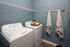 Efficient laundry room with a washer and dryer set at Abberly Alston Apartments in Cary, NC