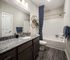 Modern bathroom with a sleek bathtub and stylish fixtures at Abberly Alston Apartments in Cary, NC