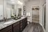 A modern bathroom featuring sleek fixtures, a bathtub, a sink, and a toilet at Abberly Alston Apartments in Cary, NC