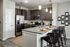 A stylish kitchen with stainless steel appliances, granite countertops, and plenty of natural light at Abberly Alston Apartments in Cary, NC