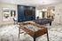 A recreational area featuring a pool table and foosball. Providing a fun and engaging space for residents to enjoy games and socialize at Abberly Alston Apartment Homes and Townhomes in Cary, NC