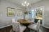 A dining room with a table, chairs, and a chandelier at Abberly Alston Townhomes in Cary, NC