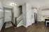 A kitchen and living room with hardwood floors at Abberly Alston Townhomes in Cary, NC