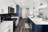 Stylish kitchen featuring white countertops and blue cabinets at Abberly Foundry Apartments in Nashville, TN