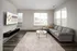 Inviting living room featuring a couch and coffee table in front of a flat-screen TV at Abberly Foundry Apartments in Nashville, TN