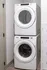 Convenient laundry room featuring a stacked washer and dryer at Abberly Foundry Apartments in Nashville, TN