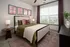 Cozy bedroom with natural light from large windows at Abberly Foundry Apartments in Nashville, TN