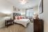 Cozy bedroom with a bed and two nightstands at Abberly Crest Apartments in Lexington Park, MD