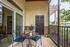 Patio with a table and chairs and a black door at Abberly Crest Apartments in Lexington Park, MD