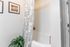 Bathroom with a bathtub and a plant in the corner at Abberly Crest Apartments in Lexington Park, MD