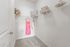Spacious walk-in closet with a pink dress hanging on the wall at Abberly Crest Apartments in Lexington Park, MD