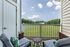 Scenic view of the patio and lush greenery from the living room at Abberly Crest Apartments in Lexington Park, MD