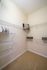 Spacious walk-in closet with ample storage, modern design, and organized shelving at Abberly Crest Apartments in Lexington Park, MD