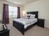 Bedroom with a bed and two nightstands at Abberly Crest Apartments in Lexington Park, MD