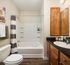 Bathroom with a large garden tub, spacious vanity, and plank flooring at Abberly Crest Apartments in Lexington Park, MD