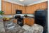 Modern kitchen with granite countertops and black appliances at Abberly Crest Apartments in Lexington Park, MD