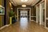 Large hallway in the clubhouse with wood floors and brown walls at Abberly Crest Apartments in Lexington Park, MD