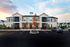 Large building with screened-in porches and ample parking at Abberly Crest Apartments in Lexington Park, MD
