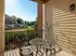 Scenic view of the patio and lush greenery from the living room at Abberly Crest Apartments in Lexington Park, MD
