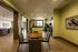 Dining area with a table and chairs and a kitchen in the background at Abberly Crest Apartments in Lexington Park, MD