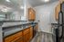 Modern kitchen with granite countertops and wood cabinets at Abberly Crest Apartments in Lexington Park, MD
