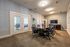 Conference room with a table, chairs, and a TV on the wall at Abberly Crest Apartments in Lexington Park, MD