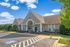Building with a parking lot in front of it at Abberly Crest Apartments in Lexington Park, MD