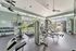 Gym with cardio equipment and windows at Abberly Crest Apartments in Lexington Park, MD