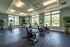 Gym with exercise bikes and windows at Abberly Crest Apartments in Lexington Park, MD