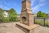 Outdoor brick fireplace with a stone mantel on a brick patio at Abberly Crest Apartments in Lexington Park, MD