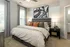 Bedroom with a large bed and a ceiling fan at Abberly Commons Apartments in Charlotte, NC
