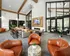 Clubhouse with leather chairs and tables at Abberly Commons Apartments in Charlotte, NC