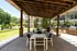 A patio with wooden pergola and BBQ grilling area at Abberly Onyx Apartments in Decatur, GA