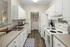 Kitchen with white cabinets at Abberly Grove Apartments in Raleigh, NC