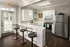 Resident clubhouse kitchen with bar at Abberly Grove Apartments in Raleigh, NC