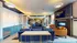 TV lounge with cafe tables and soft seating at Abberly Skye Apartments in Decatur, GA