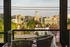 Charming balcony featuring two chairs and a table with a city view at Abberly Foundry Apartments in Nashville, TN