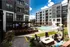 Outdoor lounge area featuring lounge chairs and a fire pit at Abberly Foundry Apartments in Nashville, TN